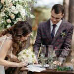 Couple signing at an outdoor wedding venue