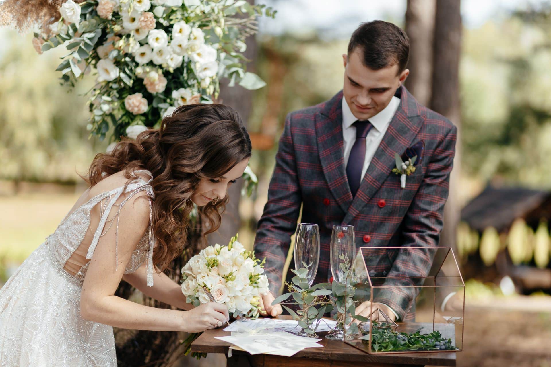 Couple signing at an outdoor wedding venue